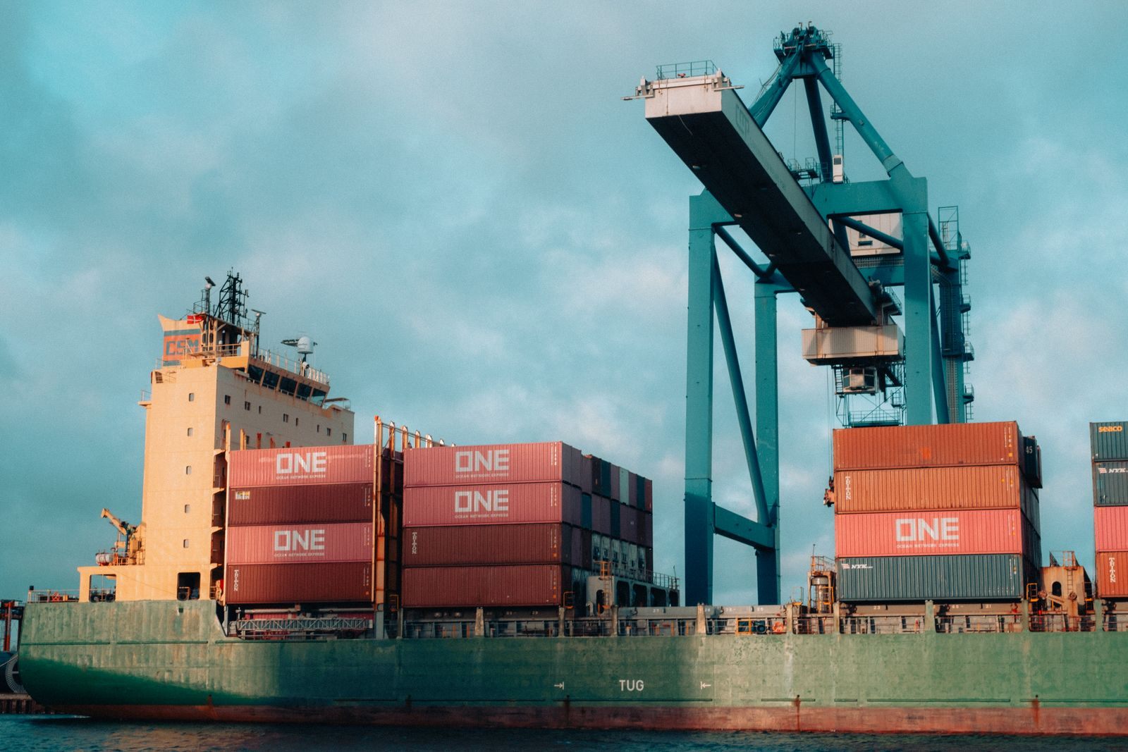 Container vessel handled by port cranes